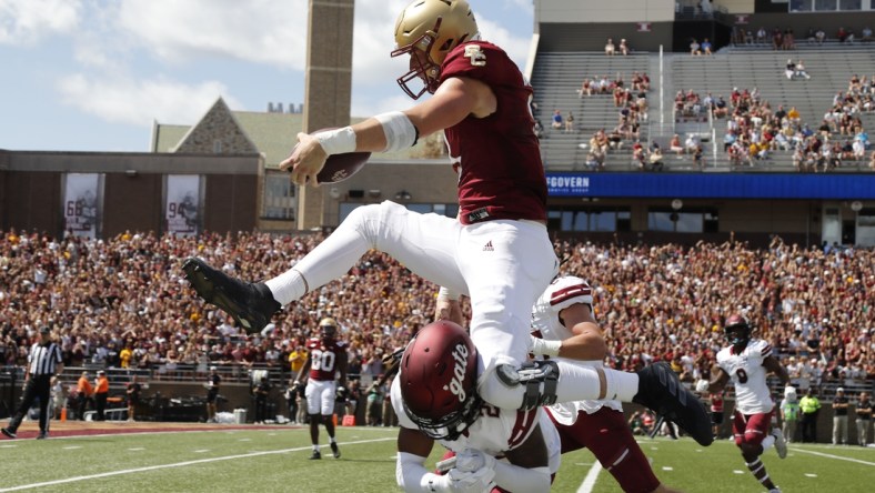 Sep 4, 2021; Chestnut Hill, Massachusetts, USA; Boston College Eagles tight end Trae Barry (3) hurdles Colgate Raiders defensive back Keshaun Dancy (20) for a touchdown during the first half at Alumni Stadium. Mandatory Credit: Winslow Townson-USA TODAY Sports