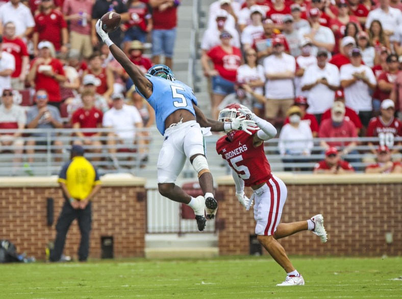 Sep 4, 2021; Norman, Oklahoma, USA;  Tulane Green Wave running back Ygenio Booker (5) makes a leaping catch in front of Oklahoma Sooners defensive back Billy Bowman (5) during the first quarter at Gaylord Family-Oklahoma Memorial Stadium. Mandatory Credit: Kevin Jairaj-USA TODAY Sports
