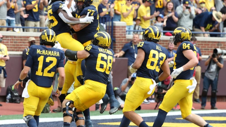 Michigan running back Blake Corum celebrates with teammates after his touchdown against Western Michigan during the first half in Ann Arbor on Saturday, Sept. 4, 2021.

Mich West