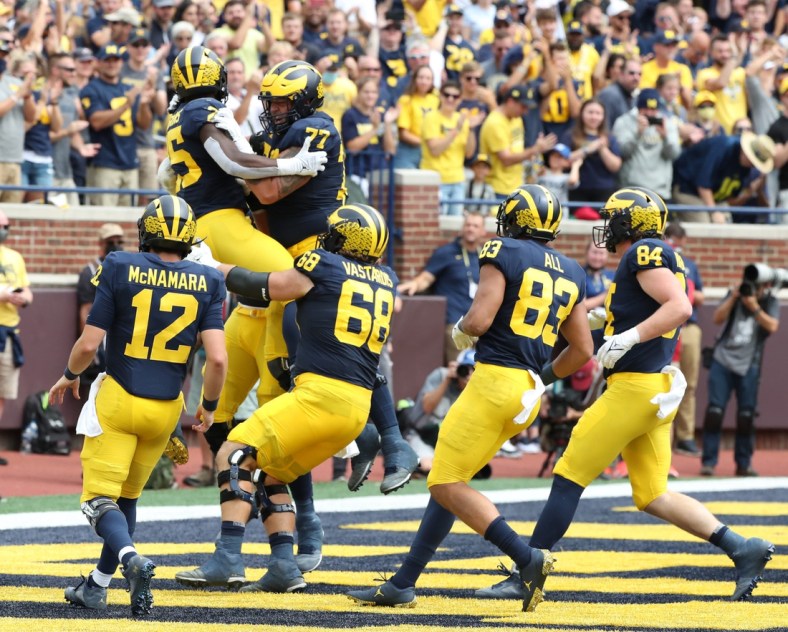 Michigan running back Blake Corum celebrates with teammates after his touchdown against Western Michigan during the first half in Ann Arbor on Saturday, Sept. 4, 2021.

Mich West