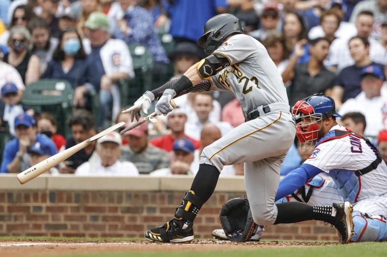 Sep 4, 2021; Chicago, Illinois, USA; Pittsburgh Pirates shortstop Kevin Newman (27) singles against the Chicago Cubs as he breaks his bat during the fourth inning at Wrigley Field. Mandatory Credit: Kamil Krzaczynski-USA TODAY Sports