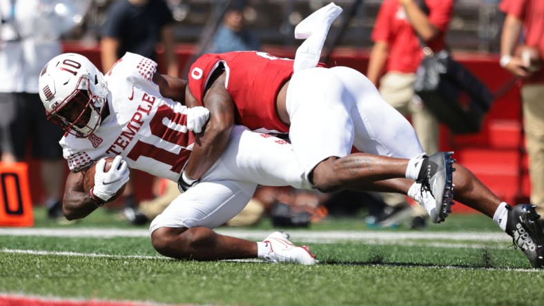 Sep 4, 2021; Piscataway, New Jersey, USA; Temple Owls wide receiver Jose Barbon (10) is tackled by Rutgers Scarlet Knights defensive back Christian Izien (0) during the second half at SHI Stadium. Mandatory Credit: Vincent Carchietta-USA TODAY Sports