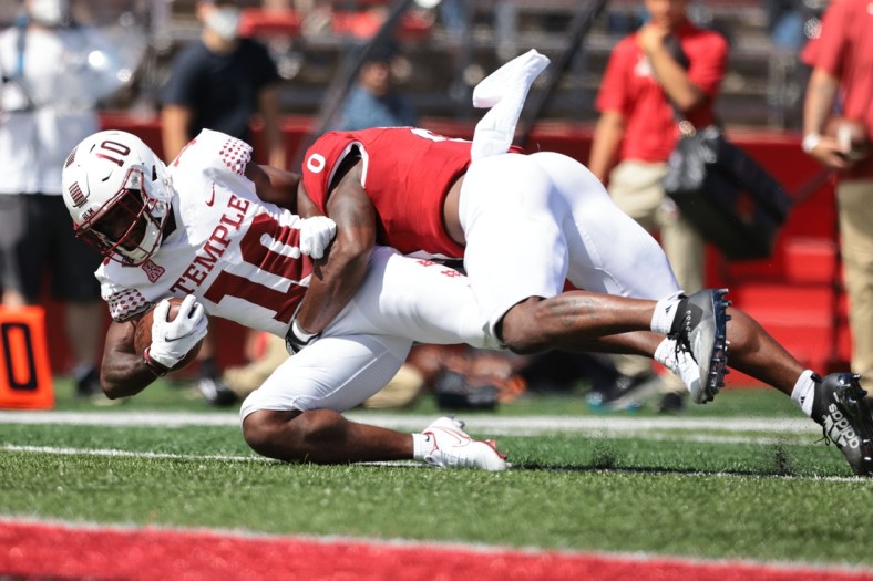 Sep 4, 2021; Piscataway, New Jersey, USA; Temple Owls wide receiver Jose Barbon (10) is tackled by Rutgers Scarlet Knights defensive back Christian Izien (0) during the second half at SHI Stadium. Mandatory Credit: Vincent Carchietta-USA TODAY Sports