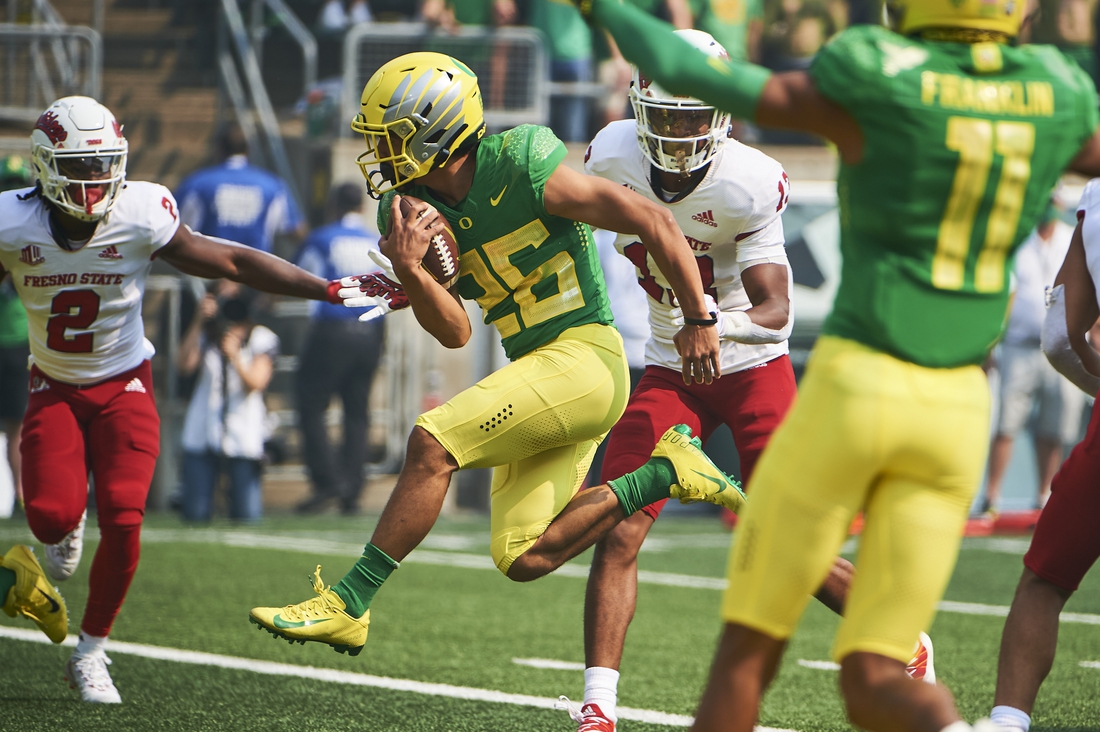 Sep 4, 2021; Eugene, Oregon, USA;  Oregon Ducks running back Travis Dye (26) scores a touchdown during the first half against the Fresno State Bulldogs at Autzen Stadium. Mandatory Credit: Troy Wayrynen-USA TODAY Sports