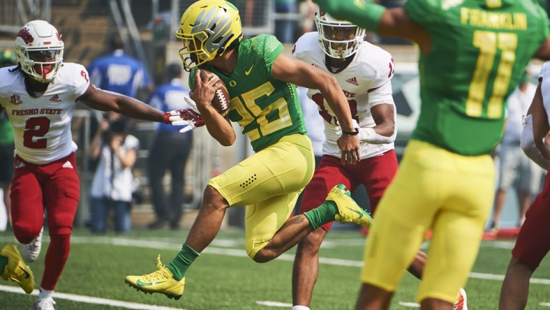 Sep 4, 2021; Eugene, Oregon, USA;  Oregon Ducks running back Travis Dye (26) scores a touchdown during the first half against the Fresno State Bulldogs at Autzen Stadium. Mandatory Credit: Troy Wayrynen-USA TODAY Sports