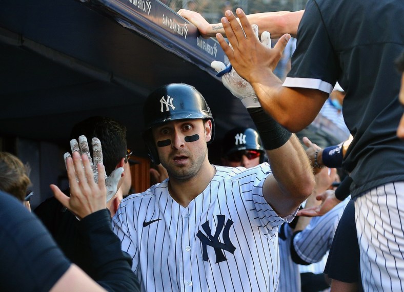 Sep 4, 2021; Bronx, New York, USA; New York Yankees left fielder Joey Gallo (13) is congratulated in the dugout after hitting a two run home run against the Baltimore Orioles during the eighth inning at Yankee Stadium. Mandatory Credit: Andy Marlin-USA TODAY Sports