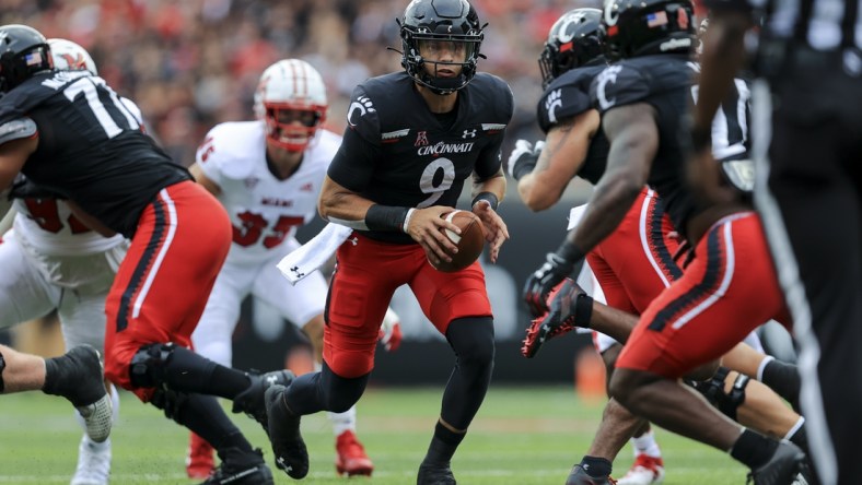 Sep 4, 2021; Cincinnati, Ohio, USA; Cincinnati Bearcats quarterback Desmond Ridder (9) tosses the ball against the Miami (Oh) Redhawks in the first half at Nippert Stadium. Mandatory Credit: Aaron Doster-USA TODAY Sports