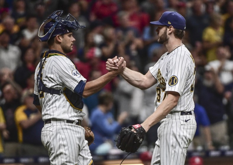 Sep 4, 2021; Milwaukee, Wisconsin, USA;  Milwaukee Brewers pitcher Adrian Houser (37) celebrates with catcher Luke Maile (12) after pitching a complete game shutout to beat the St. Louis Cardinals at American Family Field. Mandatory Credit: Benny Sieu-USA TODAY Sports