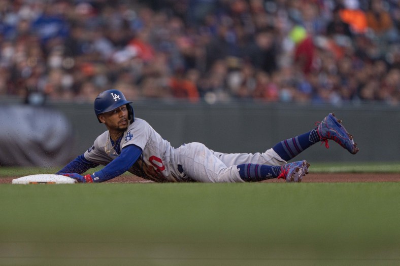 Sep 4, 2021; San Francisco, California, USA;  Los Angeles Dodgers right fielder Mookie Betts (50) slides during the first inning against the San Francisco Giants at Oracle Park. Mandatory Credit: Stan Szeto-USA TODAY Sports