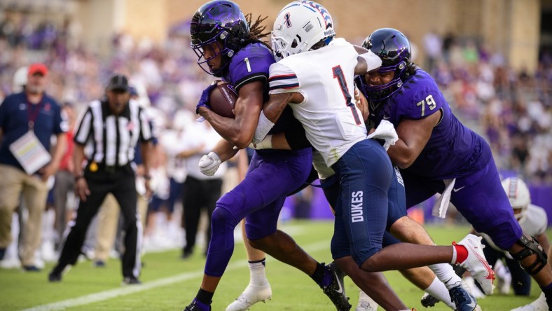 Sep 4, 2021; Fort Worth, Texas, USA; TCU Horned Frogs wide receiver Quentin Johnston (1) is tackled by Duquesne Dukes defensive back Jeremiah Josephs (1) during the first quarter at Amon G. Carter Stadium. Mandatory Credit: Jerome Miron-USA TODAY Sports