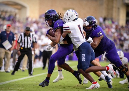 Sep 4, 2021; Fort Worth, Texas, USA; TCU Horned Frogs wide receiver Quentin Johnston (1) is tackled by Duquesne Dukes defensive back Jeremiah Josephs (1) during the first quarter at Amon G. Carter Stadium. Mandatory Credit: Jerome Miron-USA TODAY Sports