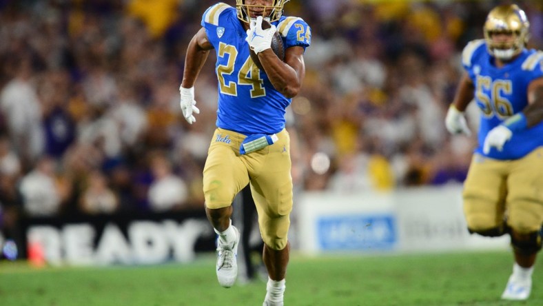 Sep 4, 2021; Pasadena, California, USA; UCLA Bruins running back Zach Charbonnet (24) runs the ball against the Louisiana State Tigers during the second half the at the Rose Bowl. Mandatory Credit: Gary A. Vasquez-USA TODAY Sports