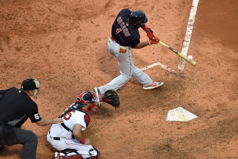 Sep 5, 2021; Boston, Massachusetts, USA;  Cleveland Indians shortstop Amed Rosario (1) hits an RBI single during the ninth inning against the Boston Red Sox at Fenway Park. Mandatory Credit: Bob DeChiara-USA TODAY Sports