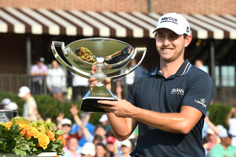 Sep 5, 2021; Atlanta, Georgia, USA; Patrick Cantlay holds up the trophy after winning the Tour Championship. Mandatory Credit: Adam Hagy-USA TODAY Sports