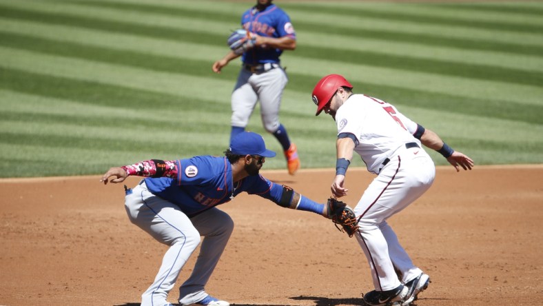 Sep 6, 2021; Washington, District of Columbia, USA; Washington Nationals catcher Alex Avila (6) runs to third base as New York Mets third baseman Jonathan Villar (1) applies a tag for an out in the second inning at Nationals Park. Mandatory Credit: Amber Searls-USA TODAY Sports