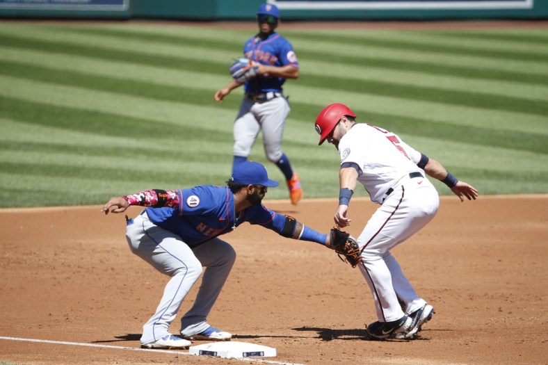Sep 6, 2021; Washington, District of Columbia, USA; Washington Nationals catcher Alex Avila (6) runs to third base as New York Mets third baseman Jonathan Villar (1) applies a tag for an out in the second inning at Nationals Park. Mandatory Credit: Amber Searls-USA TODAY Sports