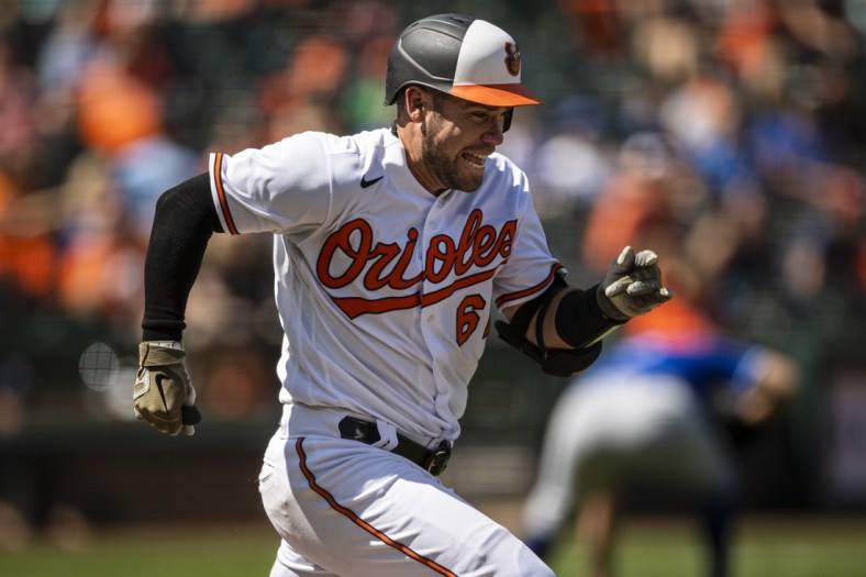 Sep 6, 2021; Baltimore, Maryland, USA; Baltimore Orioles catcher Austin Wynns (61) sprints to beat the throw to first base against the Kansas City Royals during the third inning at Oriole Park at Camden Yards. Mandatory Credit: Scott Taetsch-USA TODAY Sports