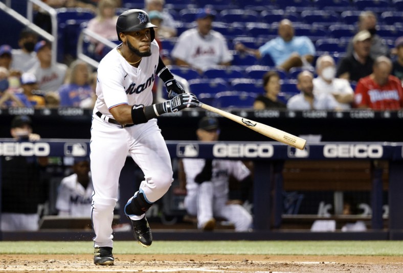 Sep 8, 2021; Miami, Florida, USA; Miami Marlins center fielder Bryan De La Cruz (77) follows through on his double against the New York Mets during the second inning at loanDepot Park Mandatory Credit: Rhona Wise-USA TODAY Sports