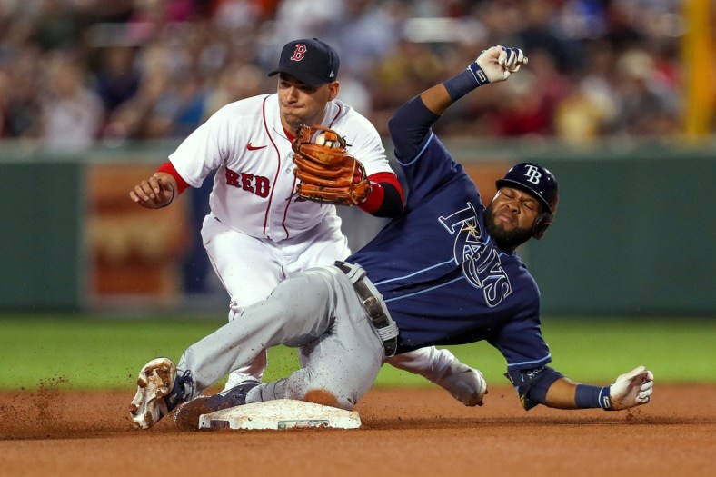 Sep 8, 2021; Boston, Massachusetts, USA; Tampa Bay Rays right fielder Manuel Margot (13) is tagged out at second base by Boston Red Sox shortstop Jose Iglesias (12) during the fourth inning at Fenway Park. Mandatory Credit: Paul Rutherford-USA TODAY Sports