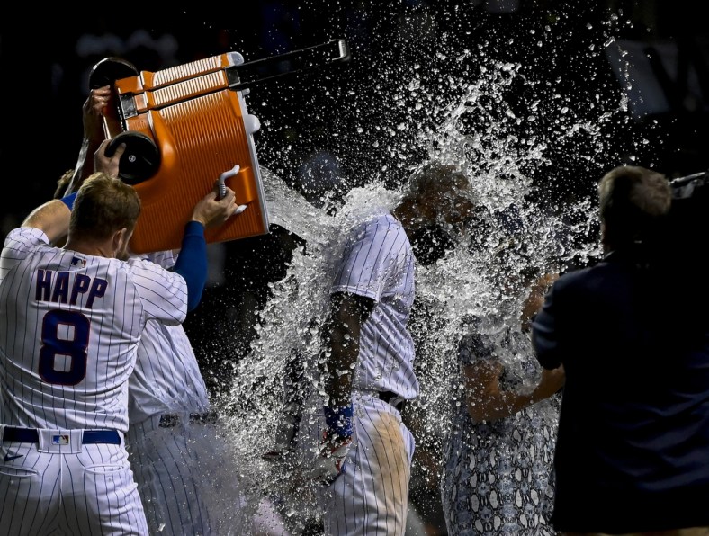 Sep 8, 2021; Chicago, Illinois, USA; Chicago Cubs right fielder Jason Heyward (22) gets doused by Chicago Cubs center fielder Ian Happ (8) after hitting a walk off three run home run against the Cincinnati Reds during the tenth inning at Wrigley Field. Mandatory Credit: Matt Marton-USA TODAY Sports
