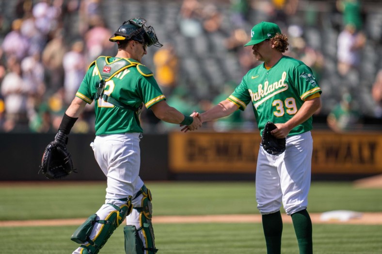 Sep 9, 2021; Oakland, California, USA;  Oakland Athletics relief pitcher Andrew Chafin (39) and Oakland Athletics catcher Sean Murphy (12) celebrate after the end of the game against the Chicago White Sox at RingCentral Coliseum. Mandatory Credit: Neville E. Guard-USA TODAY Sports