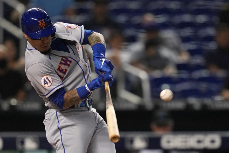 Sep 9, 2021; Miami, Florida, USA; New York Mets second baseman Javier Baez (23) hits a ground rule double in the 1st inning against the Miami Marlins at loanDepot park. Mandatory Credit: Jasen Vinlove-USA TODAY Sports