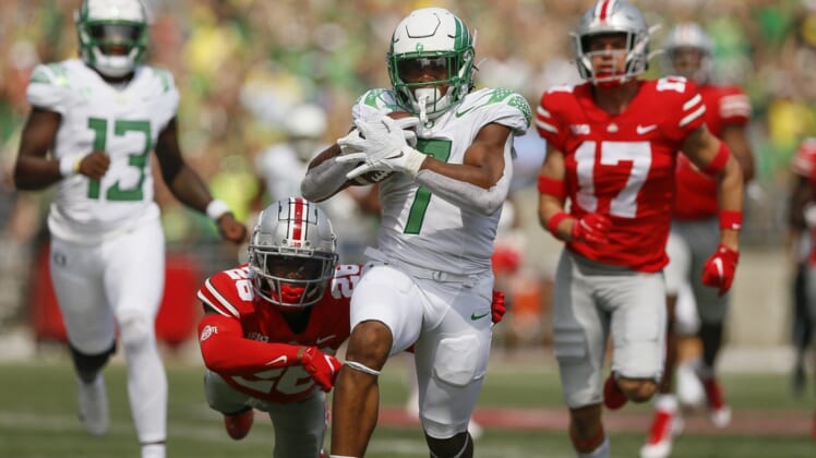 Oregon running back CJ Verdell runs past Ohio State  safety Bryson Shaw (17) and cornerback Cameron Brown (26) for a 77-yard touchdown on Saturday. Verdell scored two touchdowns.Oregon CP