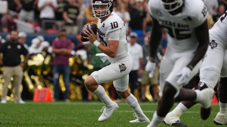 Sep 11, 2021; Denver, Colorado, USA; Texas A&M Aggies quarterback Zach Calzada (10) looks to pass in the second quarter against the Colorado Buffaloes  at Empower Field at Mile High. Mandatory Credit: Ron Chenoy-USA TODAY Sports