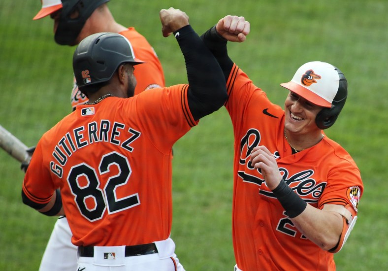 Sept. 11, 2021; Baltimore, Maryland, USA; Baltimore Orioles right fielder Austin Hays (21) celebrates with Baltimore Orioles third baseman Kelvin Gutierrez (82) after hitting a home run during the third inning against the Toronto Blue Jays at Oriole Park at Camden Yards. Mandatory Credit: Daniel Kucin Jr.-USA TODAY Sports