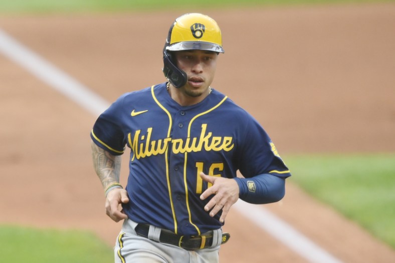 Sep 11, 2021; Cleveland, Ohio, USA; Milwaukee Brewers second baseman Kolten Wong (16) scores in the first inning against the Cleveland Indians at Progressive Field. Mandatory Credit: David Richard-USA TODAY Sports