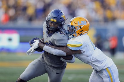 Sep 11, 2021; Morgantown, West Virginia, USA; West Virginia Mountaineers running back Leddie Brown (4) is tackled by Long Island Sharks safety Jerome Brooks III (6) during the second quarter at Mountaineer Field at Milan Puskar Stadium. Mandatory Credit: Ben Queen-USA TODAY Sports