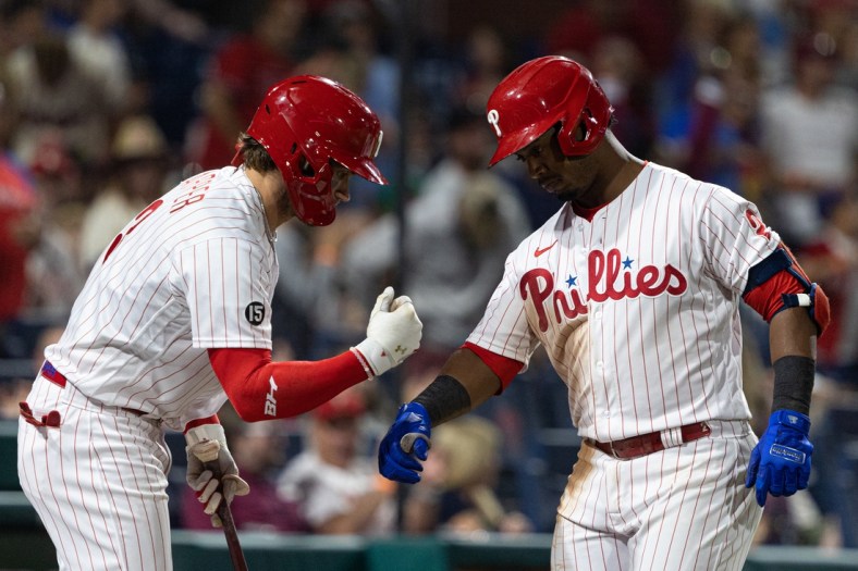 Sep 11, 2021; Philadelphia, Pennsylvania, USA; Philadelphia Phillies shortstop Jean Segura (2) celebrates with right fielder Bryce Harper (left) after hitting a home run against the Colorado Rockies during the fifth inning at Citizens Bank Park. Mandatory Credit: Bill Streicher-USA TODAY Sports
