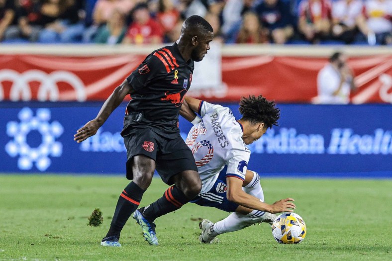 Sep 11, 2021; Harrison, New Jersey, USA; New York Red Bulls midfielder Dru Yearwood (16) battles for the ball against D.C. United midfielder Kevin Paredes (30) during the first half at Red Bull Arena. Mandatory Credit: Vincent Carchietta-USA TODAY Sports