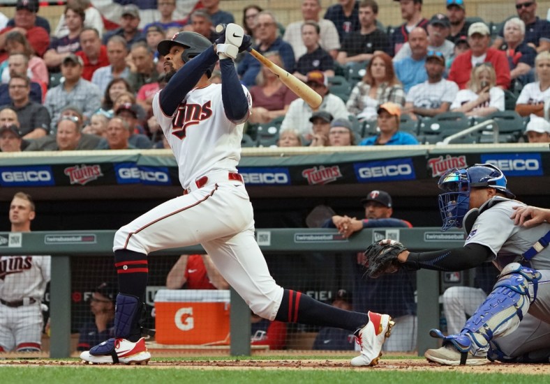 Sep 11, 2021; Minneapolis, Minnesota, USA;  Minnesota Twins outfielder Byron Buxton (25) hits a solo home run off of Kansas City Royals starting pitcher Brady Singer (51) during the first inning at Target Field. Mandatory Credit: Nick Wosika-USA TODAY Sports