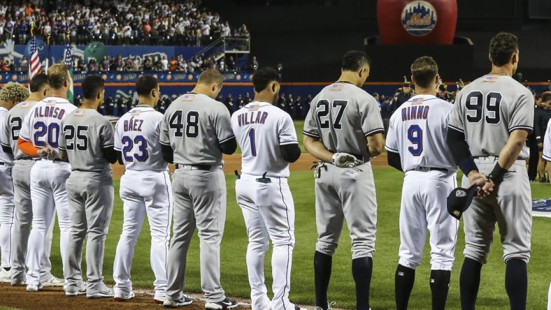 Sep 11, 2021; New York City, New York, USA;  Members of the New York Yankees and New York Mets line up next to each other during the September 11 pre-game ceremonies at Citi Field. Mandatory Credit: Wendell Cruz-USA TODAY Sports