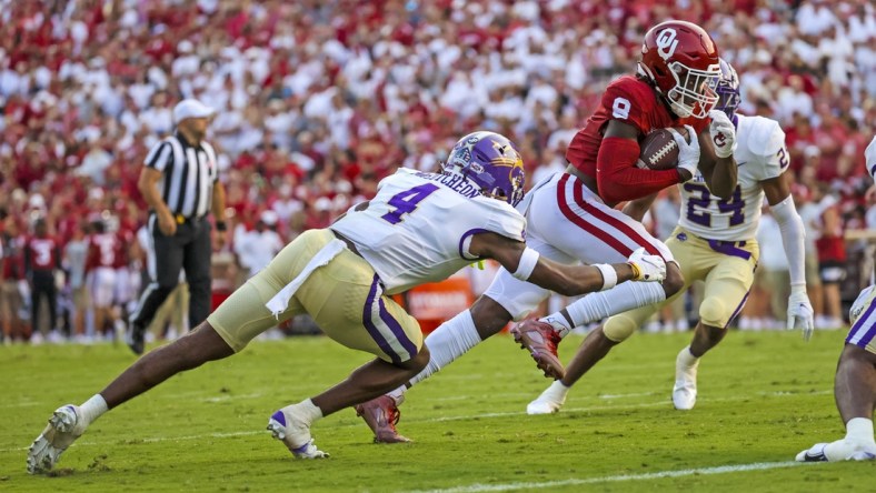 Sep 11, 2021; Norman, Oklahoma, USA; Oklahoma Sooners wide receiver Michael Woods II (8) scores a touchdown past Western Carolina Catamounts defensive back Cameron McCutcheon (4) during the second quarter at Gaylord Family-Oklahoma Memorial Stadium. Mandatory Credit: Kevin Jairaj-USA TODAY Sports