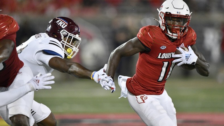 Sep 11, 2021; Louisville, Kentucky, USA;  Louisville Cardinals wide receiver Josh Johnson (11) runs the ball past the reach of Eastern Kentucky Colonels linebacker Je'Vari Anderson (14) during the second quarter at Cardinal Stadium. Mandatory Credit: Jamie Rhodes-USA TODAY Sports