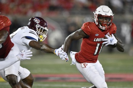 Sep 11, 2021; Louisville, Kentucky, USA;  Louisville Cardinals wide receiver Josh Johnson (11) runs the ball past the reach of Eastern Kentucky Colonels linebacker Je'Vari Anderson (14) during the second quarter at Cardinal Stadium. Mandatory Credit: Jamie Rhodes-USA TODAY Sports