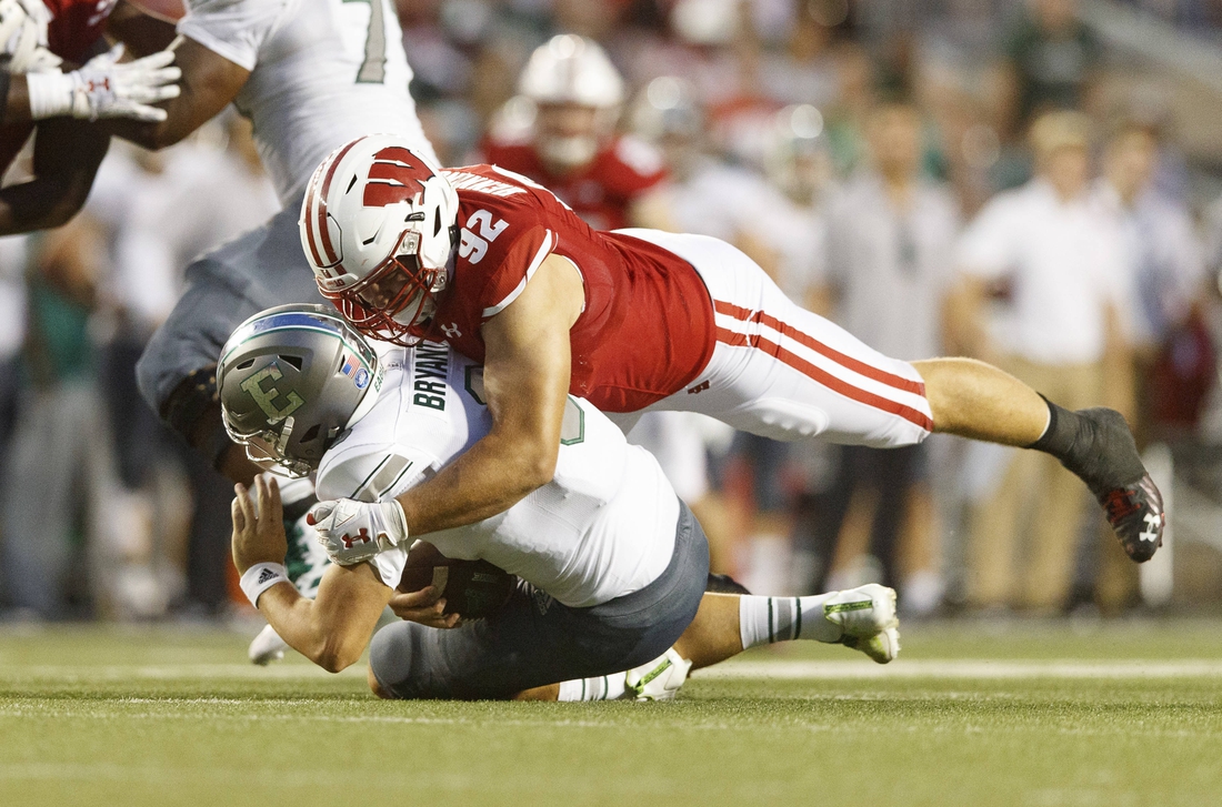 Sep 11, 2021; Madison, Wisconsin, USA;  Wisconsin Badgers defensive end Matt Henningsen (92) sacks Eastern Michigan Eagles quarterback Ben Bryant (8) during the second quarter at Camp Randall Stadium. Mandatory Credit: Jeff Hanisch-USA TODAY Sports