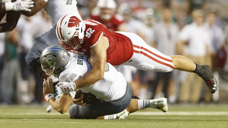 Sep 11, 2021; Madison, Wisconsin, USA;  Wisconsin Badgers defensive end Matt Henningsen (92) sacks Eastern Michigan Eagles quarterback Ben Bryant (8) during the second quarter at Camp Randall Stadium. Mandatory Credit: Jeff Hanisch-USA TODAY Sports