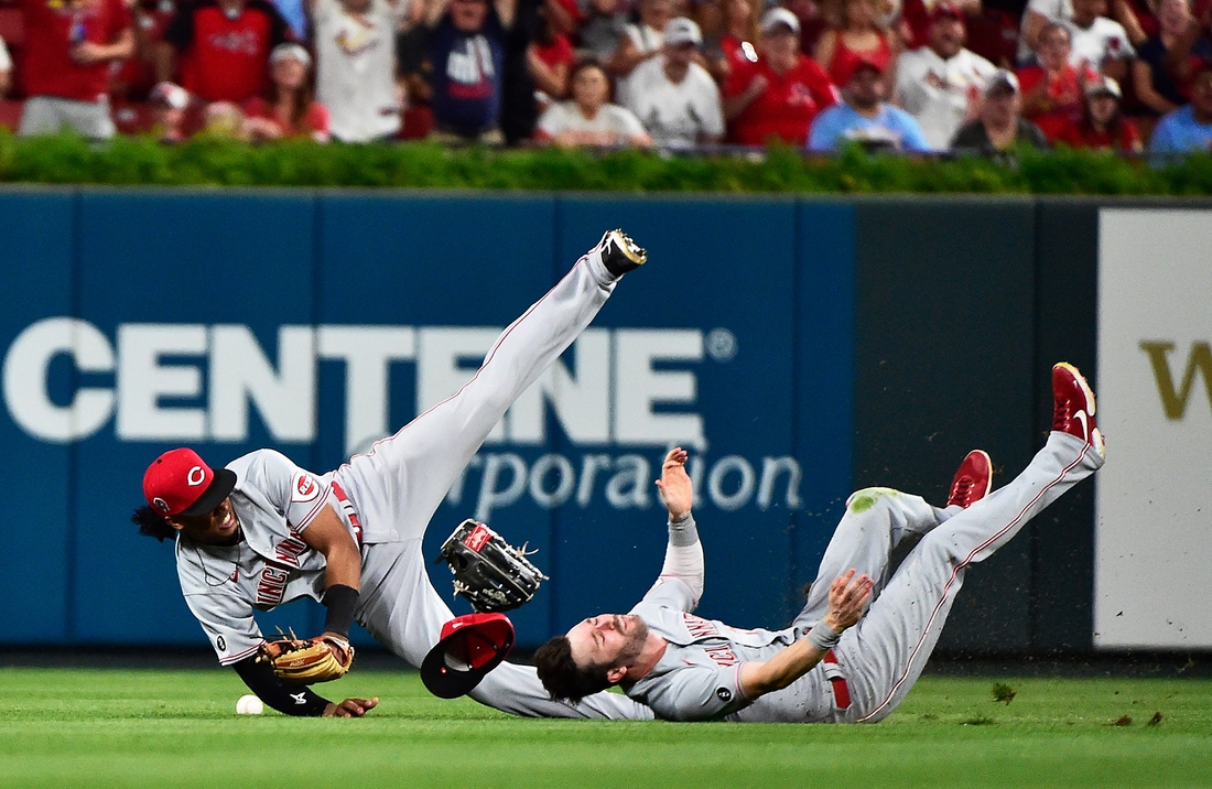 Sep 11, 2021; St. Louis, Missouri, USA;  Cincinnati Reds shortstop Jose Barrero (38) collides with center fielder Tyler Naquin (12) during the sixth inning against the St. Louis Cardinals at Busch Stadium. Mandatory Credit: Jeff Curry-USA TODAY Sports