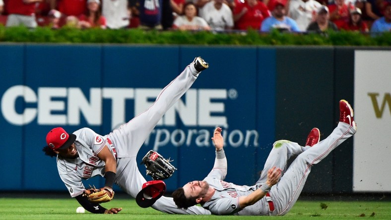 Sep 11, 2021; St. Louis, Missouri, USA;  Cincinnati Reds shortstop Jose Barrero (38) collides with center fielder Tyler Naquin (12) during the sixth inning against the St. Louis Cardinals at Busch Stadium. Mandatory Credit: Jeff Curry-USA TODAY Sports