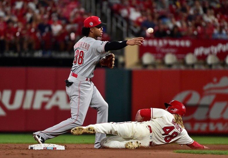 Sep 11, 2021; St. Louis, Missouri, USA;  Cincinnati Reds shortstop Jose Barrero (38) turns a double play as St. Louis Cardinals center fielder Harrison Bader (48) slides during the fifth inning at Busch Stadium. Mandatory Credit: Jeff Curry-USA TODAY Sports