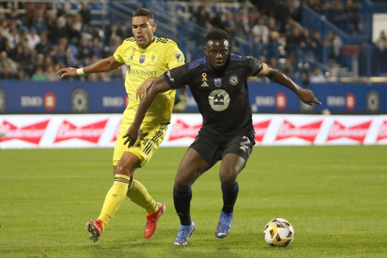Sep 11, 2021; Montreal, Quebec, CAN; CF Montreal midfielder Victor Wanyama (2) plays the ball against Nashville SC forward Daniel Rios (14) during the first half at Stade Saputo. Mandatory Credit: Jean-Yves Ahern-USA TODAY Sports