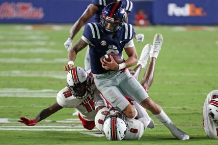 Sep 11, 2021; Oxford, Mississippi, USA; Mississippi Rebels quarterback Matt Corral (2) runs the ball against Austin Peay Governors defensive back Shamari Simmons (16) and defensive back Isaiah Norman (8) during the second quarter at Vaught-Hemingway Stadium. Mandatory Credit: Petre Thomas-USA TODAY Sports