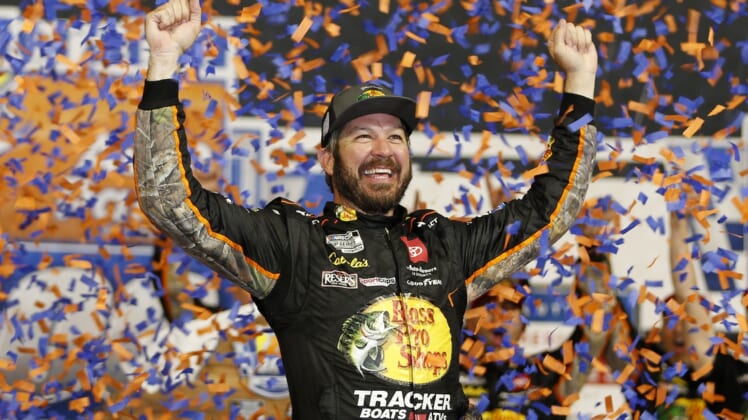 Sep 11, 2021; Richmond, Virginia, USA; NASCAR Cup Series driver Martin Truex Jr. (19) celebrates in victory lane after winning the Federated Auto Parts 400 Salute to First Responders at Richmond International Raceway. Mandatory Credit: Amber Searls-USA TODAY Sports