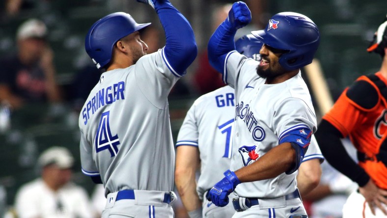 Sept. 11, 2021; Baltimore, Maryland, USA; Toronto Blue Jays shortstop Marcus Semien (10) celebrates with Toronto Blue Jays center fielder George Springer (4) after hitting a home run during the seventh inning against the Baltimore Orioles at Oriole Park at Camden Yards. Mandatory Credit: Daniel Kucin Jr.-USA TODAY Sports