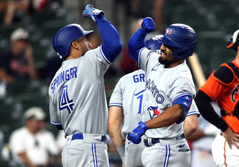 Sept. 11, 2021; Baltimore, Maryland, USA; Toronto Blue Jays shortstop Marcus Semien (10) celebrates with Toronto Blue Jays center fielder George Springer (4) after hitting a home run during the seventh inning against the Baltimore Orioles at Oriole Park at Camden Yards. Mandatory Credit: Daniel Kucin Jr.-USA TODAY Sports