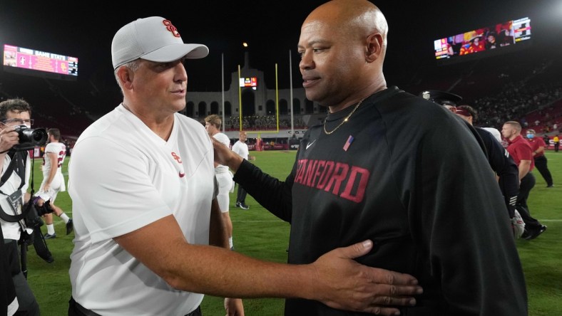 Sep 11, 2021; Los Angeles, California, USA; Southern California Trojans head coach Clay Helton and Stanford Cardinal head coach David Shaw shake hands after a game at United Airlines Field at Los Angeles Memorial Coliseum. Mandatory Credit: Kirby Lee-USA TODAY Sports