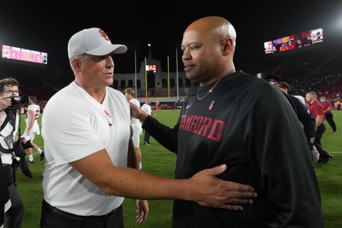 Sep 11, 2021; Los Angeles, California, USA; Southern California Trojans head coach Clay Helton and Stanford Cardinal head coach David Shaw shake hands after a game at United Airlines Field at Los Angeles Memorial Coliseum. Mandatory Credit: Kirby Lee-USA TODAY Sports